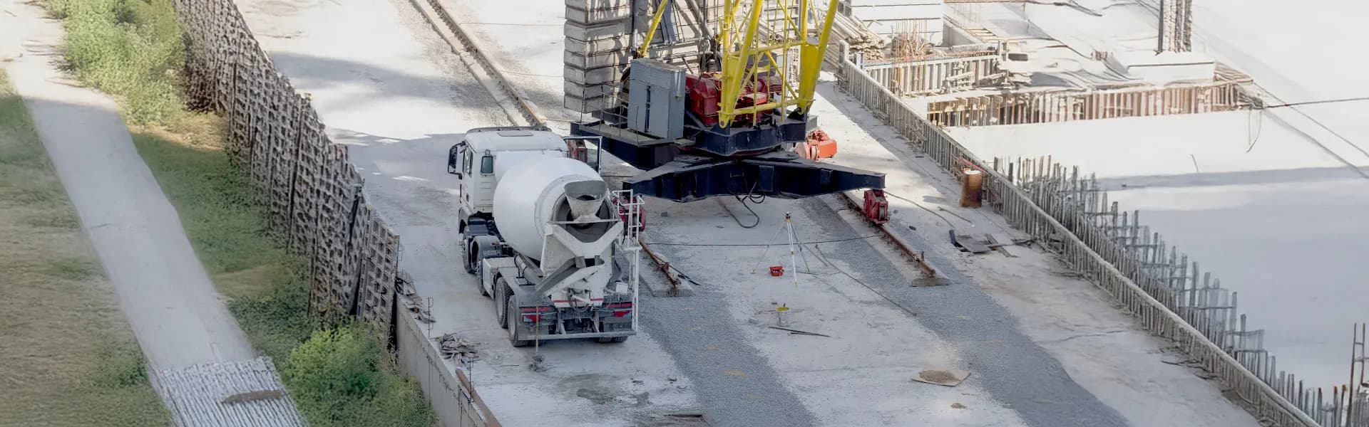Image of Concrete mixer truck driving on a construction site