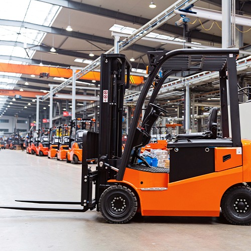 an orange forklift in a warehouse