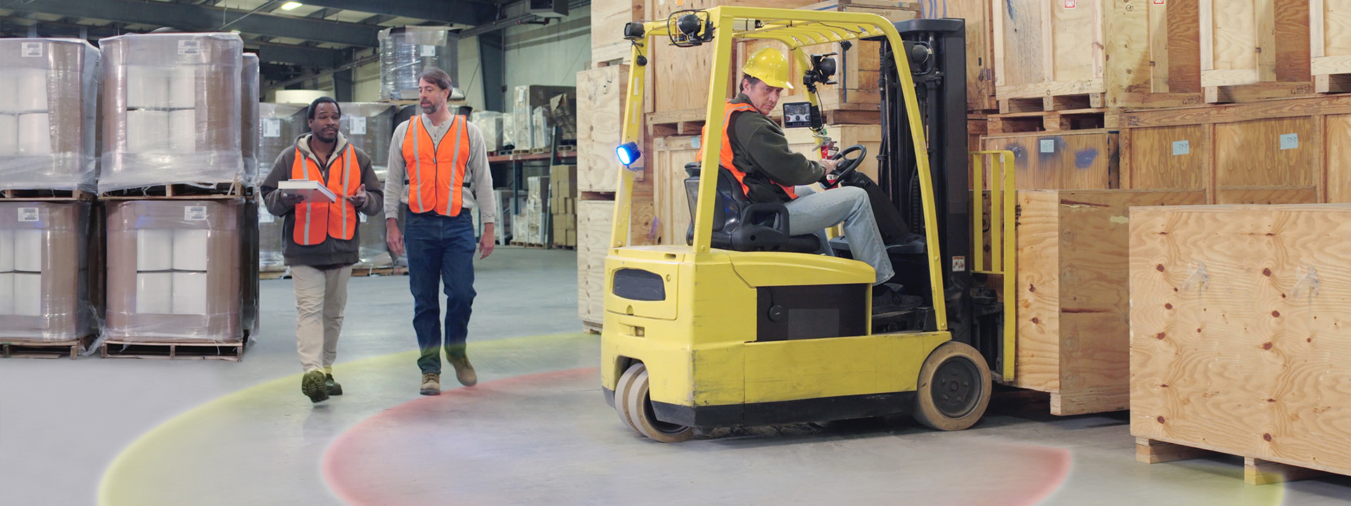 warehouse workers walking behind a forklift
