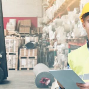 A warehouse manager and a worker operating the forklift