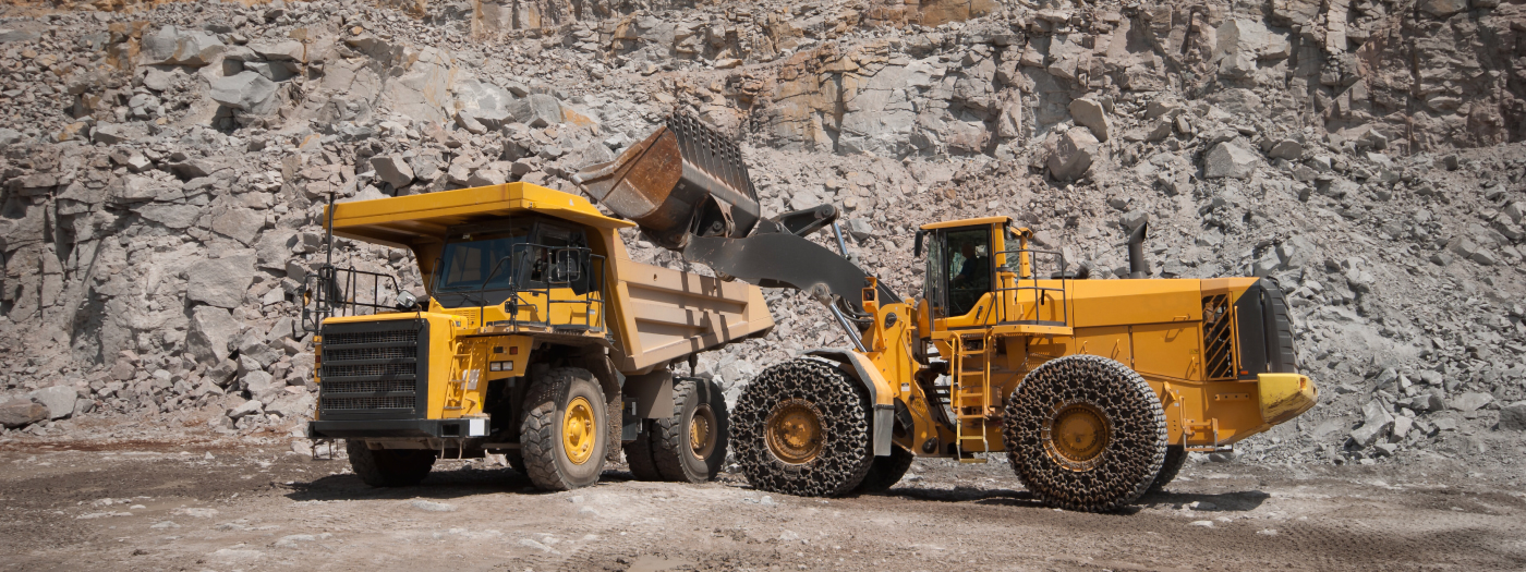 a loader and a a hauler in a quarry