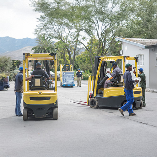 multiple forklifts driving in close proximity
