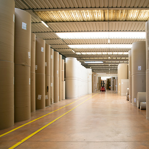 pulp and paper warehouse, skid steers are used in here
