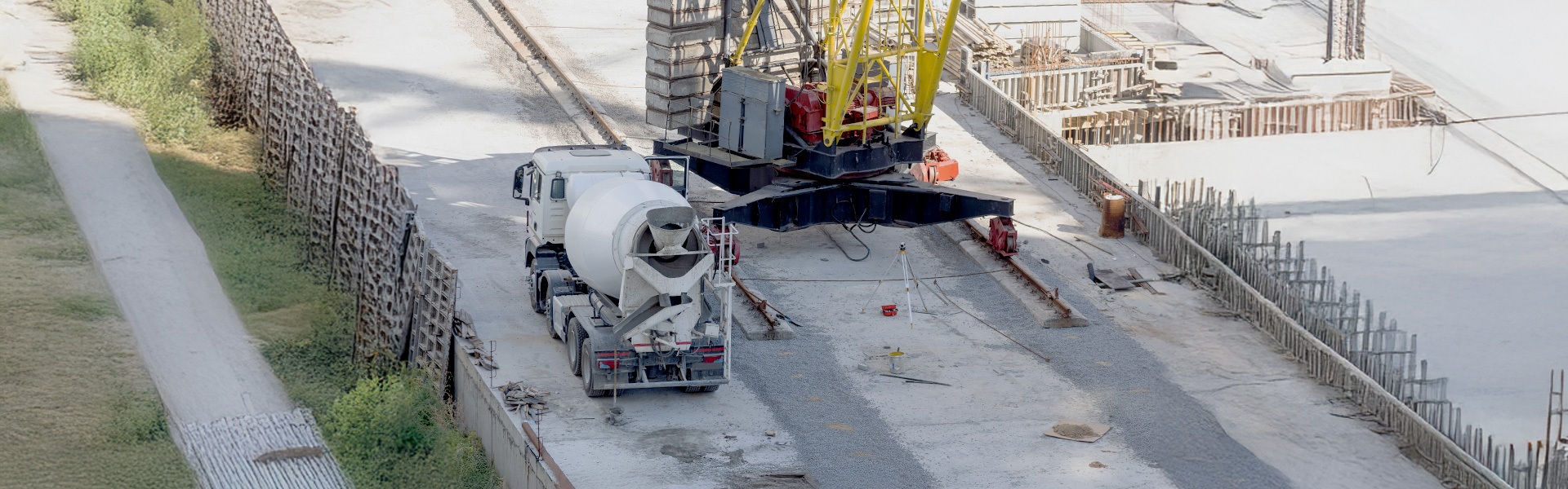 Image of Concrete mixer truck driving on a construction site
