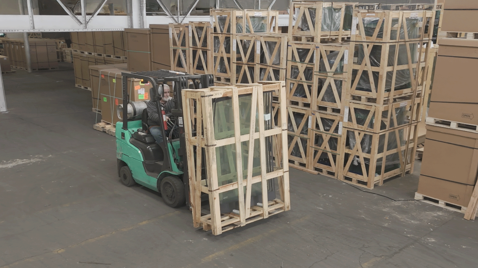 forklift carrying glass pallets